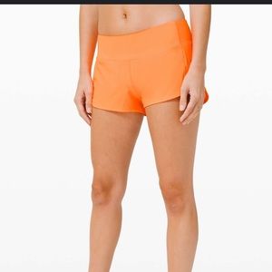 orange LULULEMON speed up 2.5” shorts